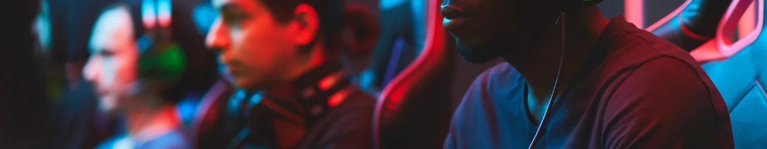 Focused eSports players in a competitive gaming environment with RGB lighting and headsets.